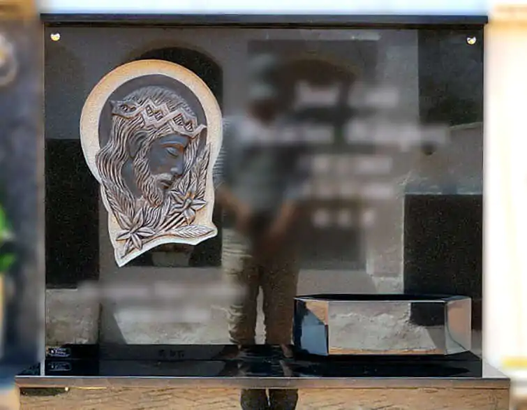 Lápida con Cristo con flores tallado